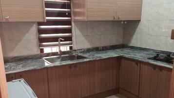 Fridge, electric kettle, cleaning supplies