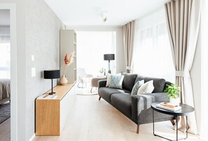 Comfort Apartment | Living area | 43-inch TV with digital channels, heated floors - Lamira Serviced Apartments Zurich City (Zürich)