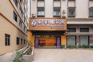A building with a sign for 'Sotiya Apartment' and a visible entrance. - Boluo Yanting Business Apartment (Boluo)