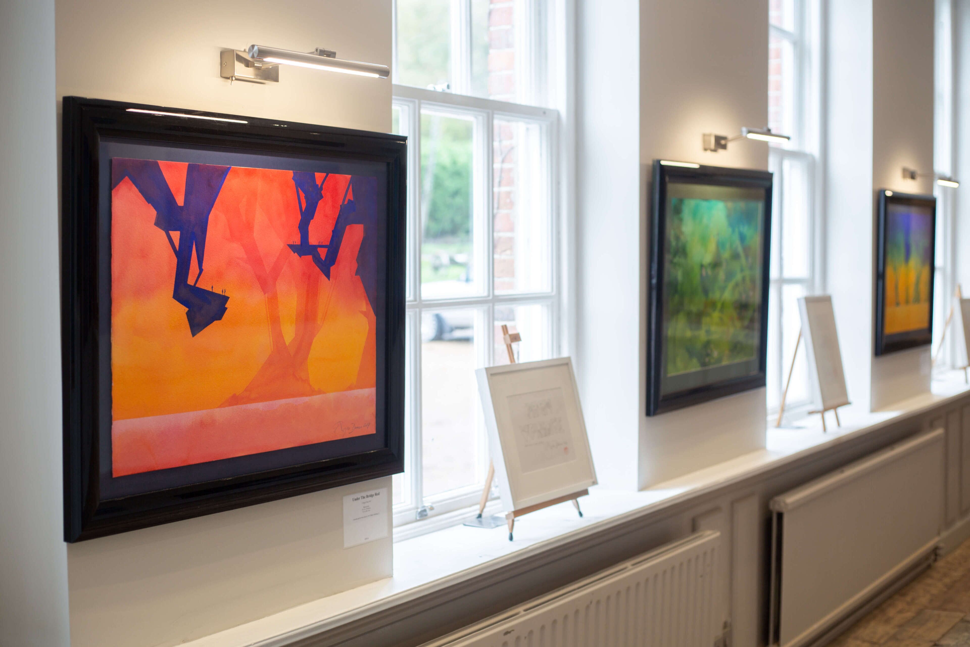 A gallery with framed artworks on display.