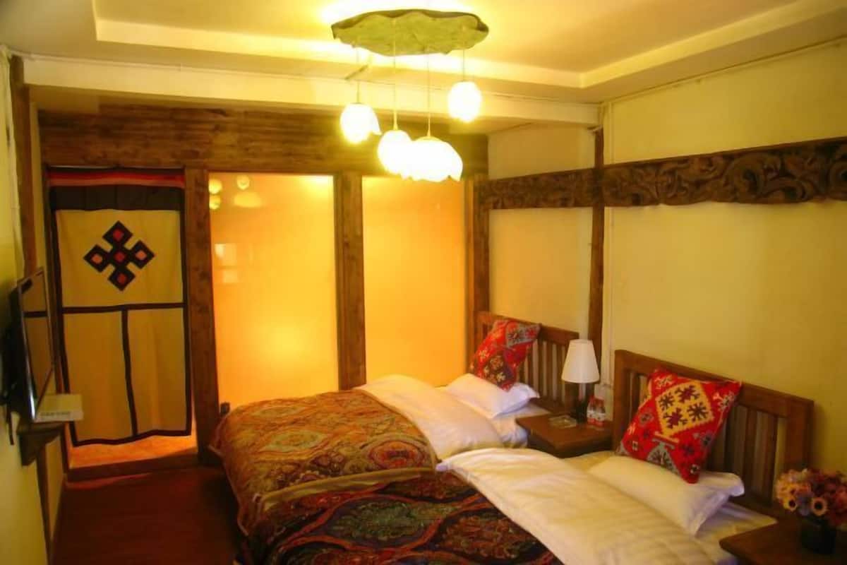 A traditional room with a bed, wooden headboard, and a decorative door.