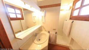 A bathroom with a sink, mirror, towel rack, and shower. - Hotel Residence Porto Piccolo (Arzachena)