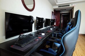 A long desk with multiple monitors, a keyboard, and a mouse.