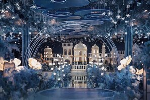 A grand building with multiple domes and arches, surrounded by decorative lights and floral arrangements. - Yarui Holiday Garden Hotel (Guangshui)