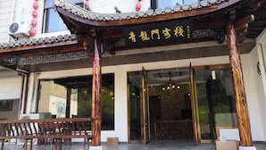 A traditional Chinese building with a tiled roof and wooden pillars.