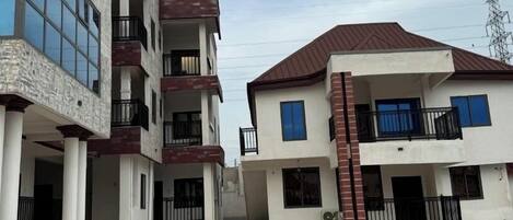 A modern multi-story residential building with a courtyard.