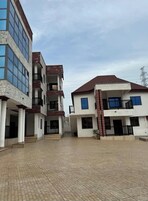 A modern multi-story residential building with a courtyard.