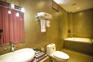 A bathroom with a sink, toilet, and bathtub.
