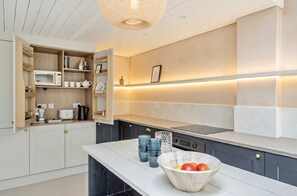 Enjoy convenient access to essentials in this kitchen with a microwave, toaster, and coffee maker.