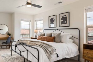 A bedroom with a bed, a desk, a chair, a round mirror, and two framed pictures on the wall. - Red Rock Adventures: Pickleball, YouTube TV (Washington)