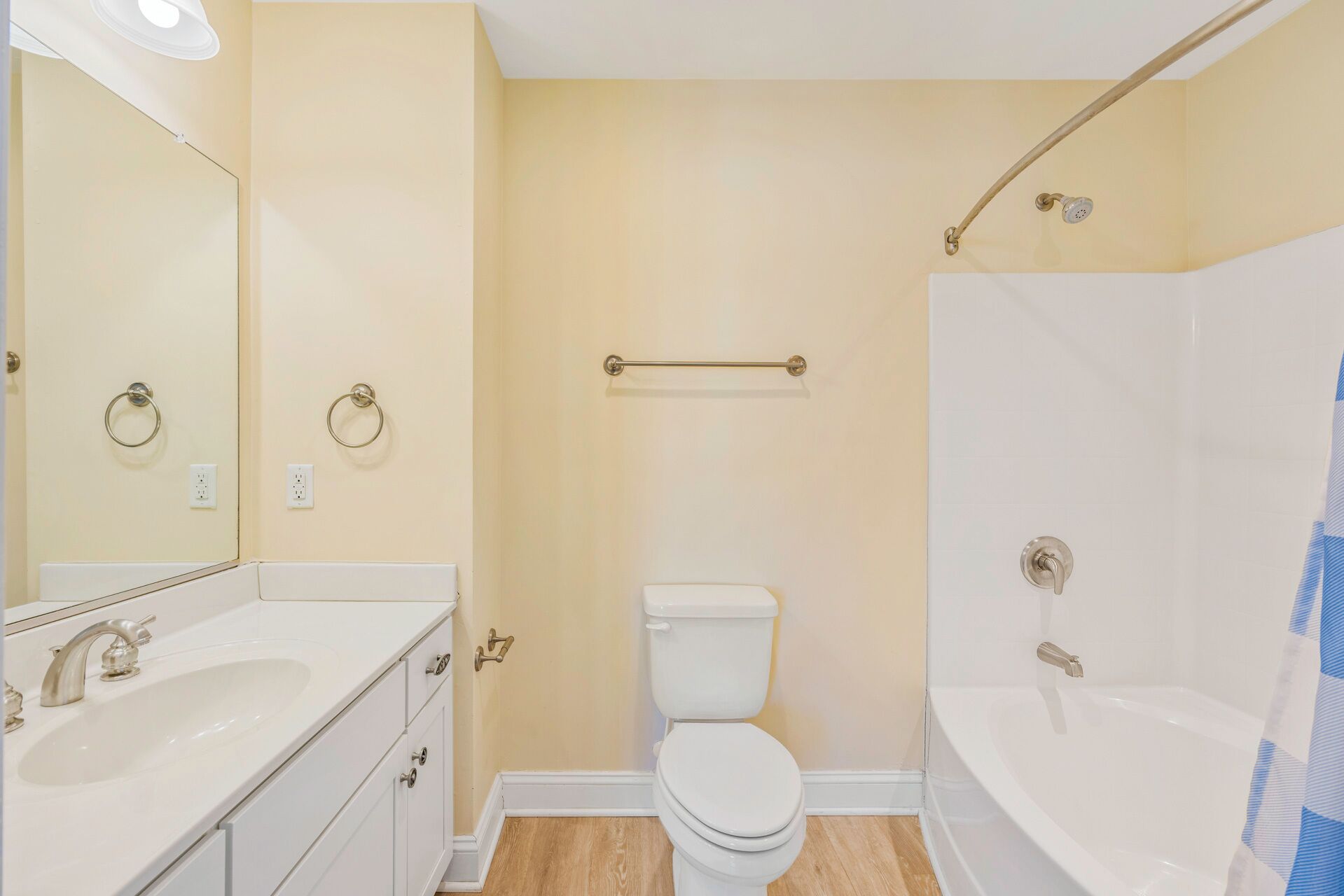 A bathroom with a sink, toilet, and bathtub.