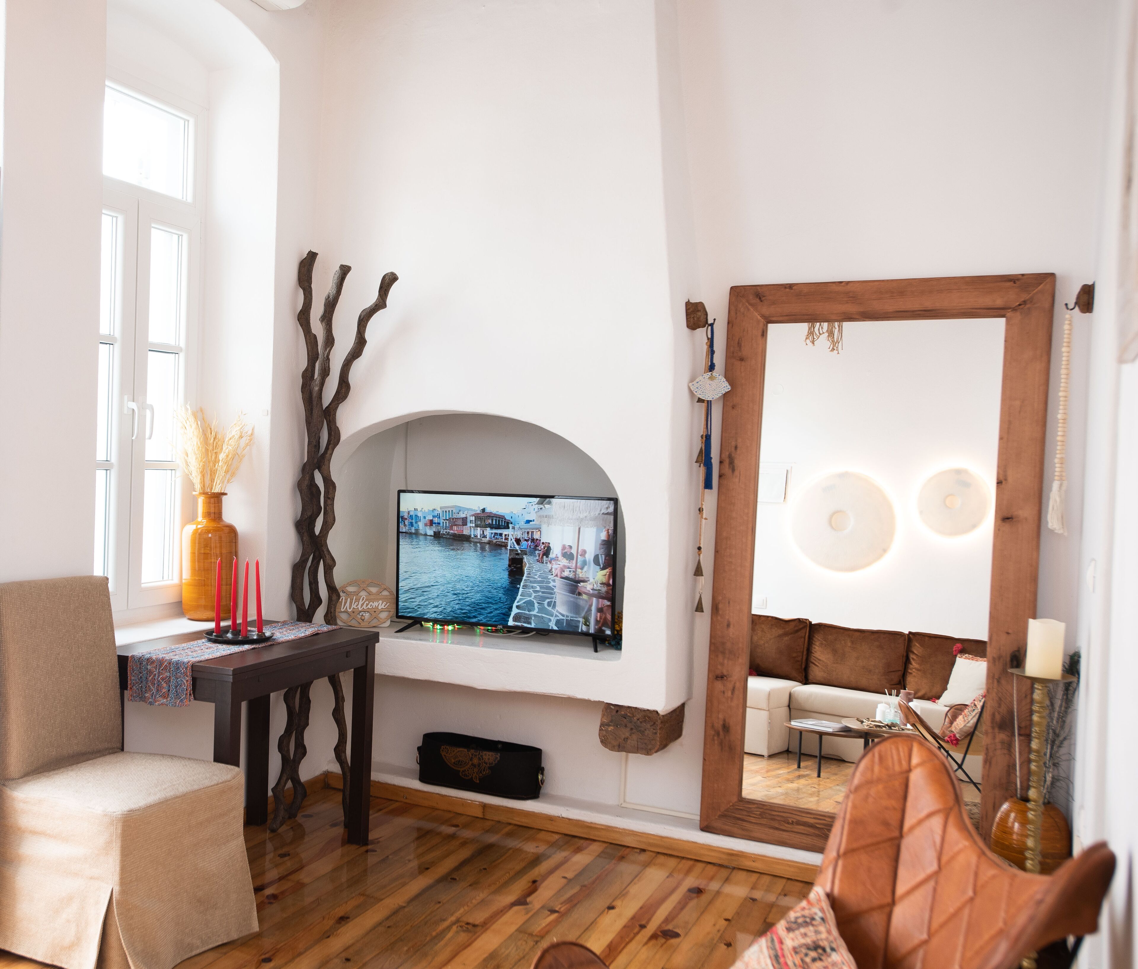 A living room with a TV, a sofa, a coffee table, and a fireplace.