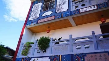 A multi-story building with traditional architectural elements, including ornate decorations and signage.