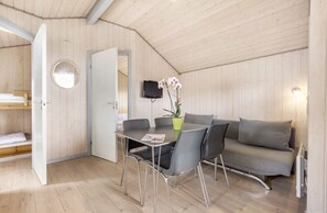 Cozy retreat with a dining area, sofa, and TV, perfect for a compact stay.