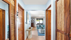 A hallway leading to a living area with a sofa and a table. - Spacious Home w/ Private Pool & Covered Patio Near the Beach (Potrero)