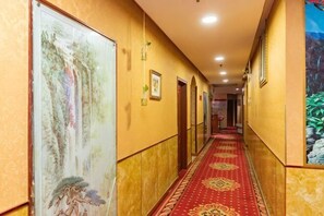 A hallway with a red carpet, framed artwork, and doors leading to rooms. - Chongqing Yuanjing Hotel (Xietaizi Metro Station Keyuan 4th Road Branch) (Chongqing)