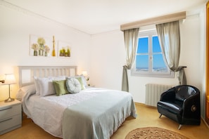 A bedroom with a bed, nightstands, a chair, a window with curtains, and wall art. - 6 Bedroom Luxury Villa ,6 seater Jacuzzi & heated pool . 18 guests max  (Mutxamel)