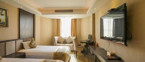 A hotel room with two beds, a desk, a chair, a TV, and a large window.