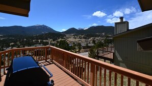 A balcony with a view of a town and mountains. - Twin Sisters - 2 bedroom 2 bathroom townhouse (Estes Park)