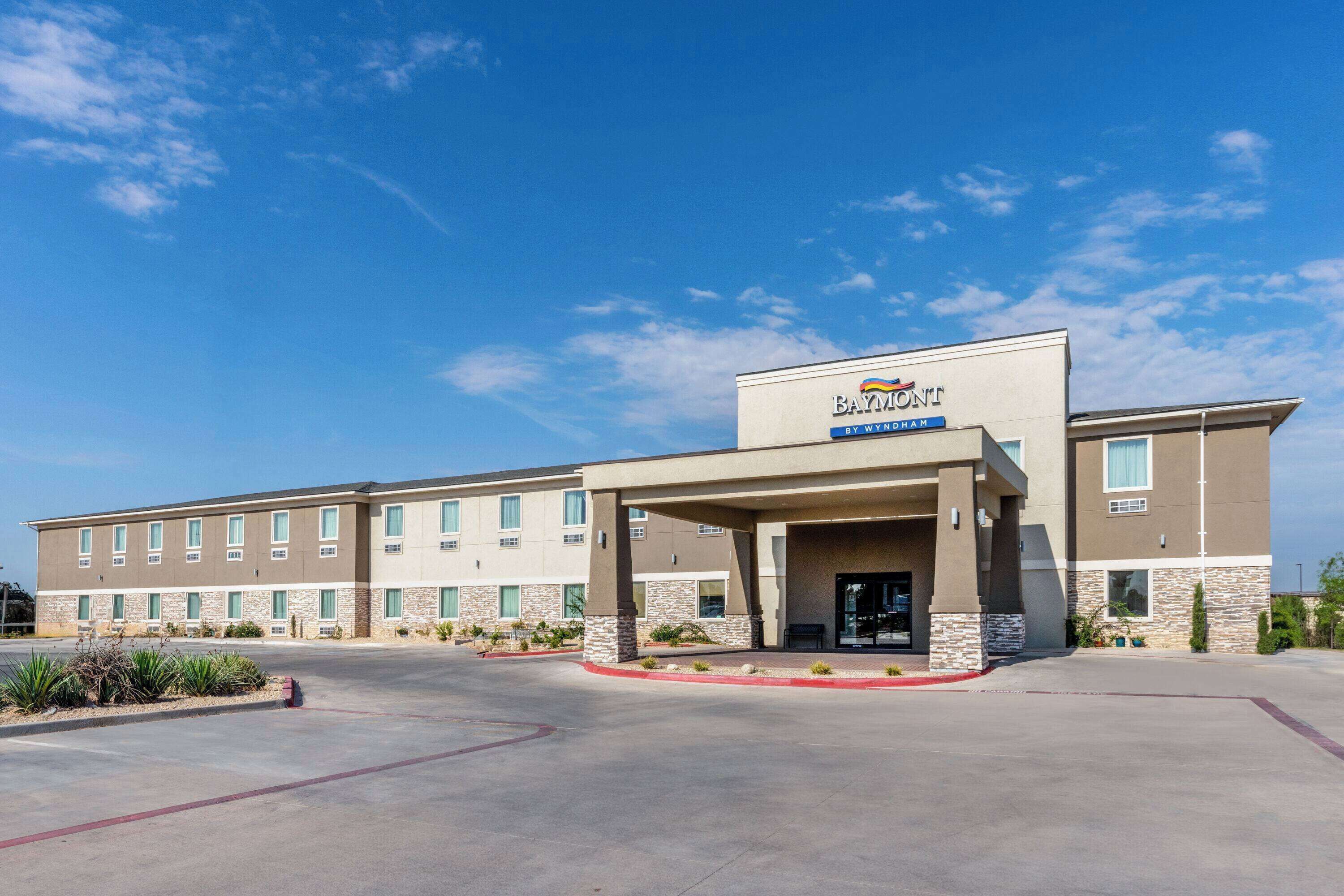 A Baymont hotel with a modern design, featuring a flat roof and a covered entrance.