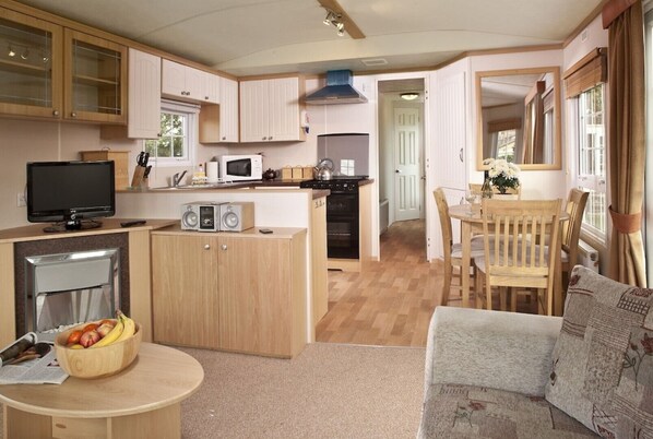 Cozy living space with a kitchenette, dining area, and comfortable sofa.