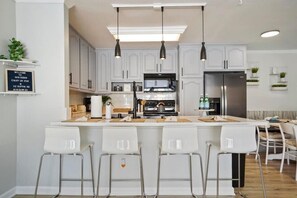Enjoy cooking in this well-equipped kitchen with a central island and stainless steel appliances.