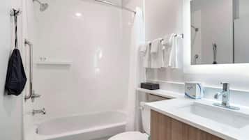 A modern bathroom with a bathtub, toilet, and sink.