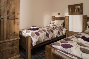 Cozy retreat with a wooden bed, wardrobe, and bedside table.