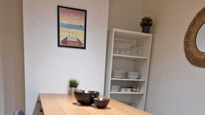 A dining table with two chairs, a small potted plant, and a framed picture on the wall. - Le Portel Plage (Le Portel)