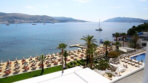 A coastal hotel with a pool, sun loungers, and umbrellas. - Agaya Bodrum +16 Adult Only (Ex.Prive Bodrum) - All inclusive (Bodrum)