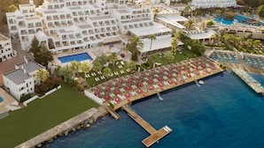 An aerial view of a coastal hotel with multiple white buildings, a swimming pool, and a dock extending into the sea. - Agaya Bodrum +16 Adult Only (Ex.Prive Bodrum) - All inclusive (Bodrum)