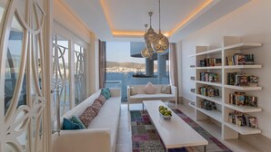 A modern living room with a sofa, coffee table, and bookshelves. - Agaya Bodrum +16 Adult Only (Ex.Prive Bodrum) - All inclusive (Bodrum)