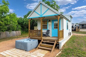 A small house with a porch, a hot tub, and a deck. - Life's a Beach - 3 Acres with Hot Tub (Fredericksburg)