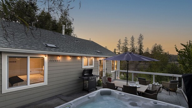 A house with a hot tub, outdoor seating, and a barbecue area. - Forest Heights ~ Relaxed Modern-Boho Style, Forest Views, Hot Tub, Wine Country (Forestville)