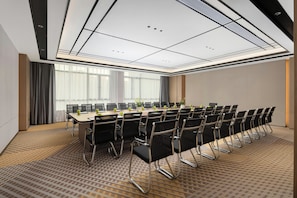 A conference room with a long table, chairs, and a large window with curtains.