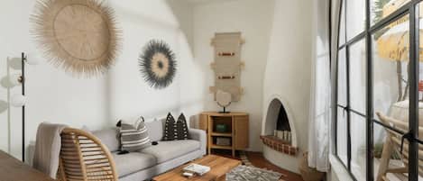 A living room with a sofa, coffee table, and decorative wall art.