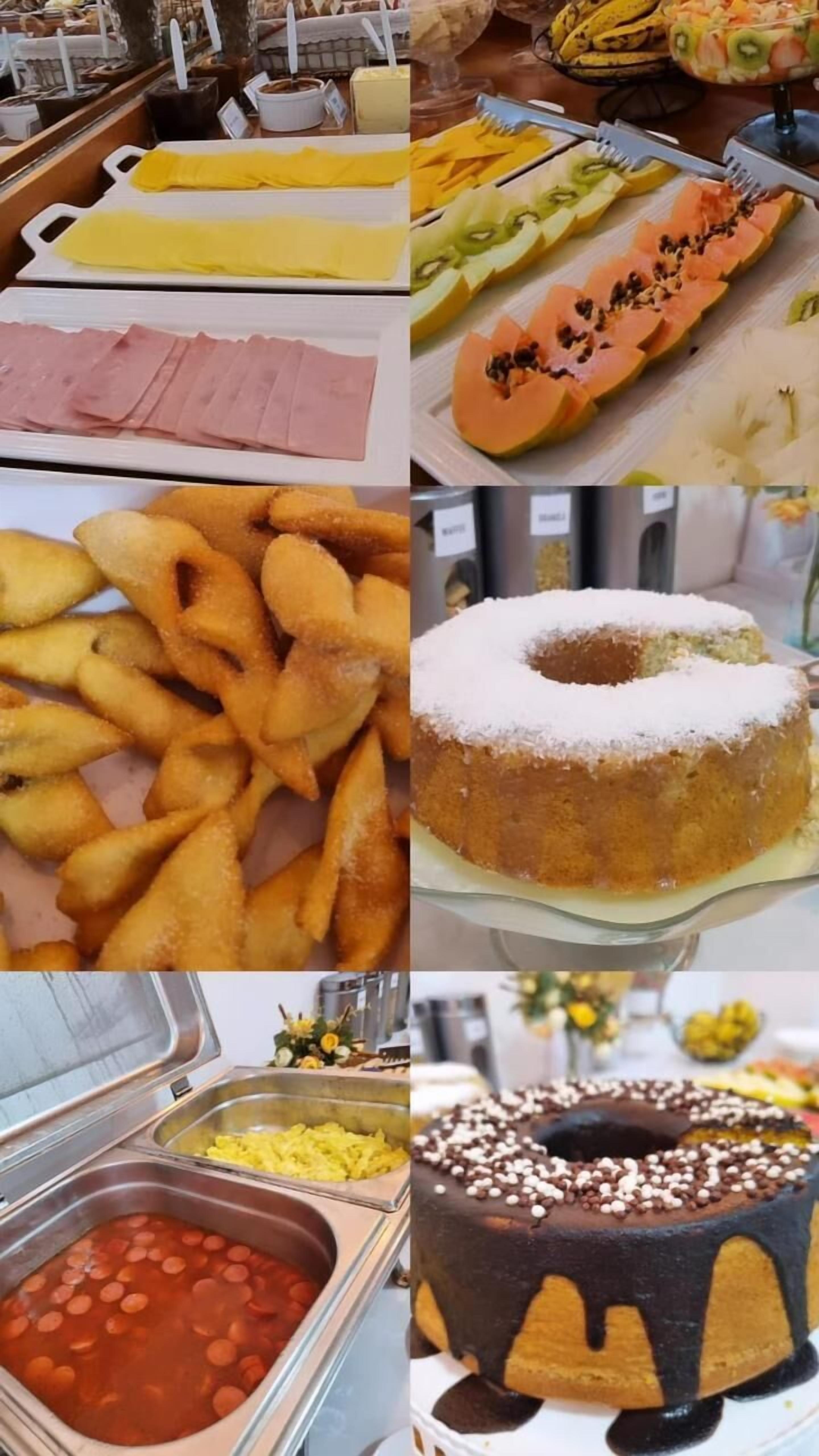 A buffet with various food items including sliced meats, fruits, fried snacks, a cake, and a dessert with chocolate drizzle.