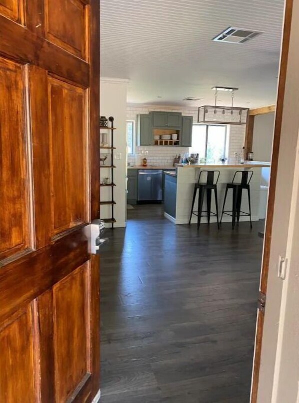 Enter a spacious kitchen with a central island and oven, perfect for cooking and socializing.