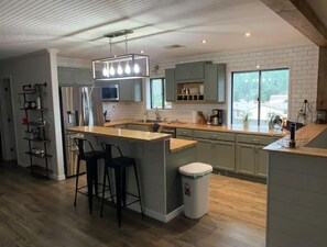Enjoy cooking in this well-equipped kitchen with a central island and bar stool seating.