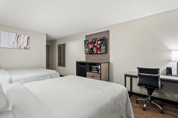 A hotel room with two beds, a desk with a computer, a TV, and a microwave. - Red Roof Inn PLUS+ Belleville (Belleville)
