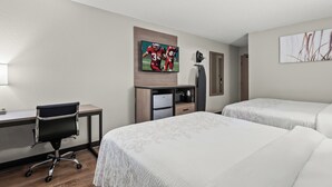 A hotel room with two beds, a desk, a chair, a TV, and artwork on the walls. - Red Roof Inn PLUS+ Belleville (Belleville)
