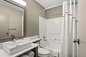 A modern bathroom with a sink, mirror, toilet, and bathtub. - Red Roof Inn PLUS+ Belleville (Belleville)
