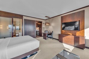 A hotel room with a large bed, a desk with a chair, a TV mounted on the wall, and a sliding door leading to a bathroom. - Vdara Studio Suite 011 * Pool View*Free Valet (Las Vegas)
