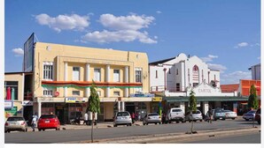 A street view with a building labeled "The Capitol" and another building with a sign "PostNet". - Backpacker's rest stop -10 min from downtown & a hike to the Falls!! (Livingstone)