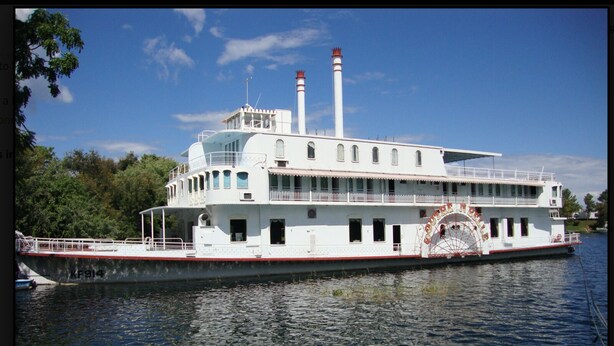 A large paddle steamer with a prominent wheelhouse, multiple decks, and a tall chimney. - Backpacker's rest stop -10 min from downtown & a hike to the Falls!! (Livingstone)
