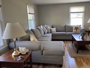 Relax in this inviting living room with a comfortable sofa, side table, and lamp.