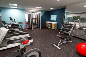 A gym with treadmills, weight machines, and a wall-mounted TV. - Avid Hotel Staunton (Staunton)