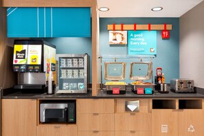 A breakfast station with a coffee machine, a vending machine, and a toaster. - Avid Hotel Staunton (Staunton)