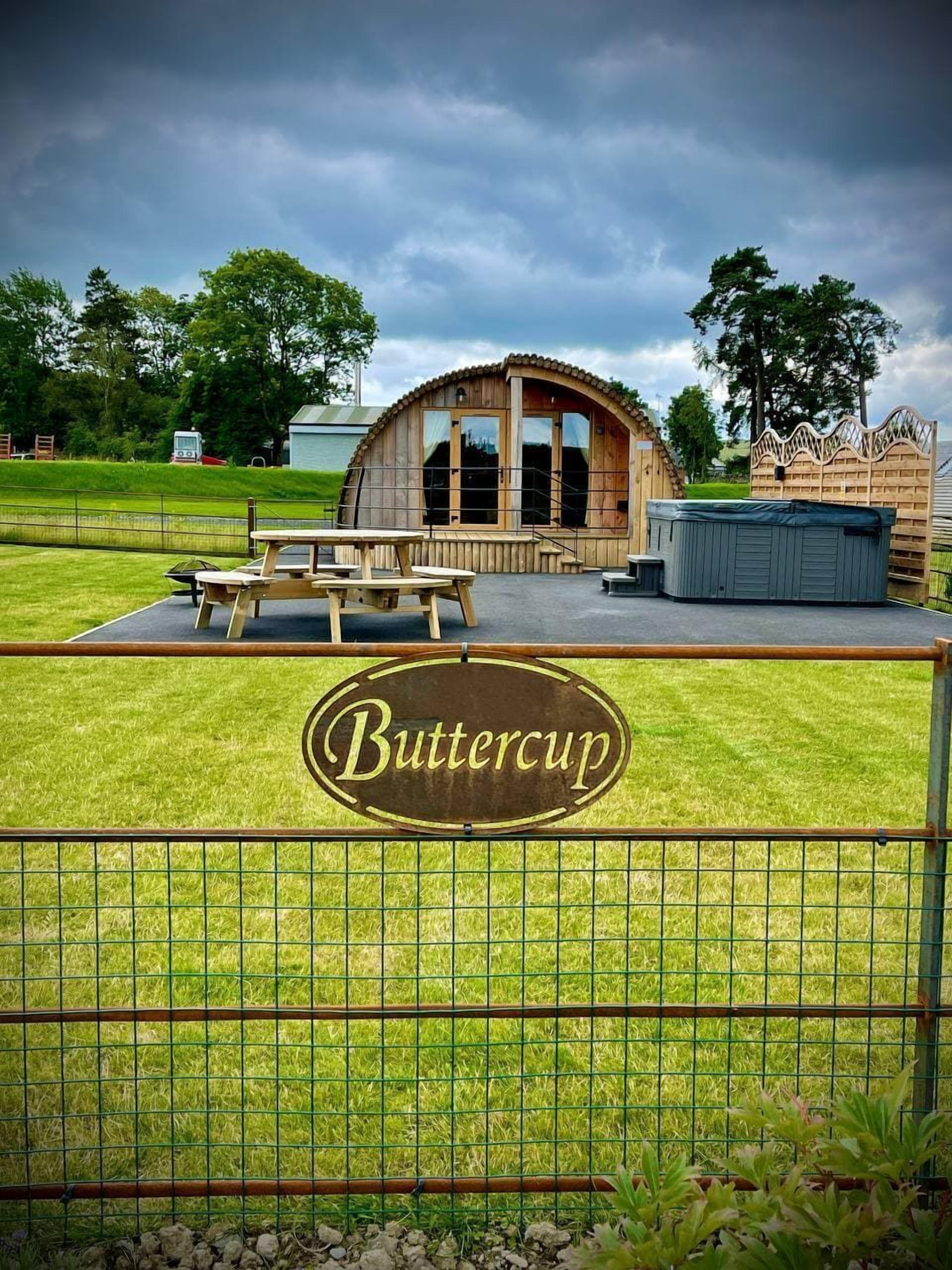 A wooden building with a sign reading "Buttercup" in front.