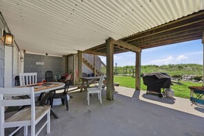 An outdoor patio area with a covered seating area, a barbecue grill, and a view of the surrounding landscape. - Hazels Castle Huge 2 in 1 Oceanfront House near  Pier (North Myrtle Beach)